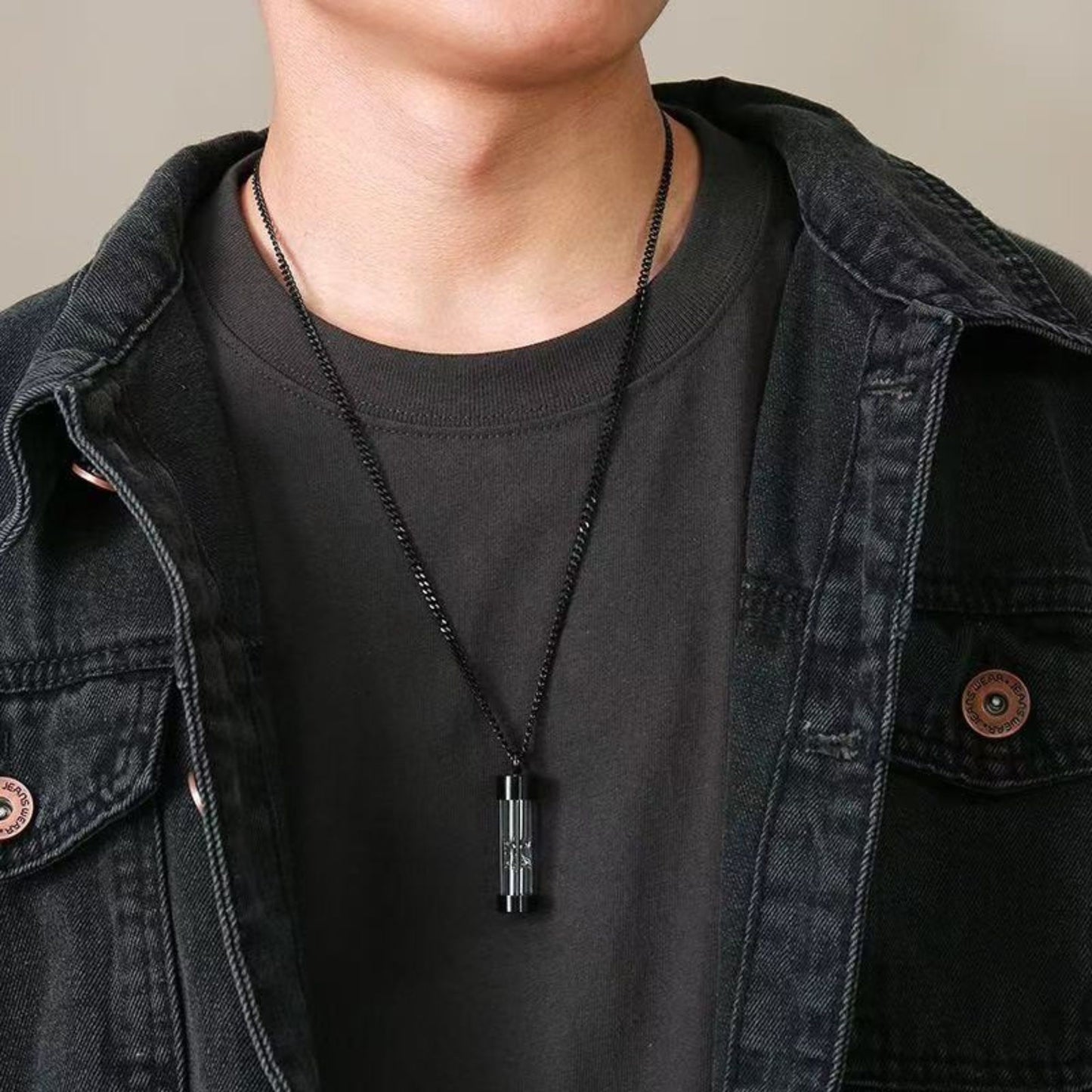 Model wearing black hourglass glass urn memorial necklace, unisex keepsake pendant.