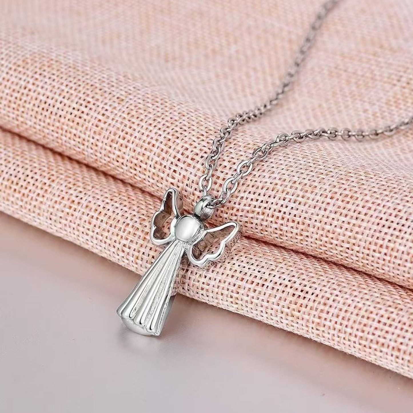 Lifestyle image: Angel wings pet memorial necklace worn on chain as a discreet keepsake remembrance jewelry