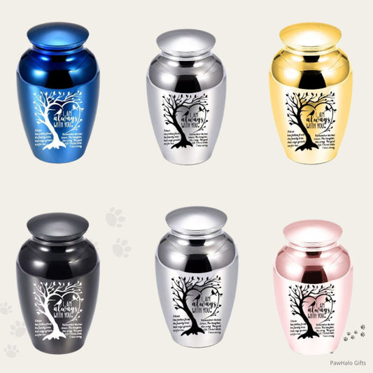 Small pet memorial urns in blue, silver, gold, black, and pink, featuring engraved tree artwork and remembrance quote for dog or cat ashes.