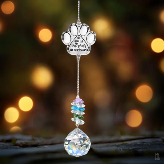 Engraved paw-print pet memorial suncatcher with clear crystal prism hanging in window