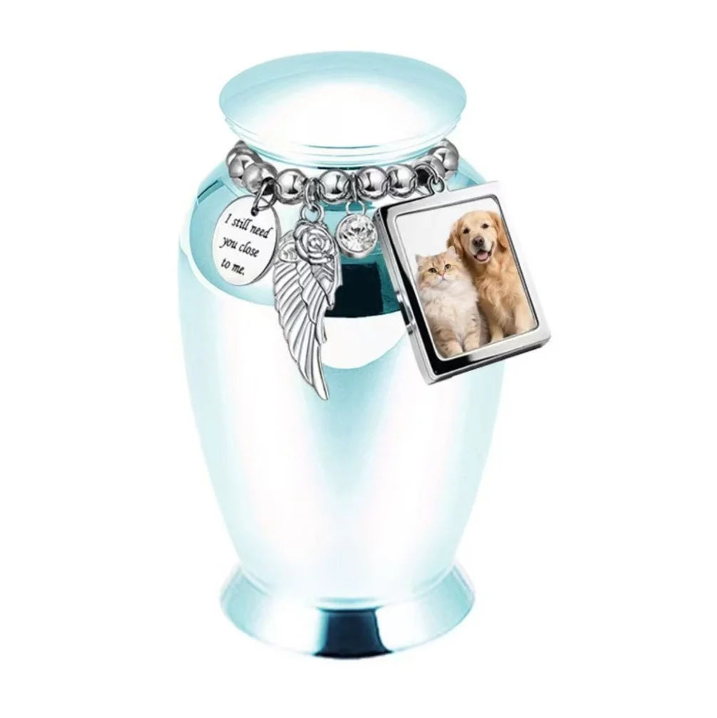 Isolated front view of the light blue personalized pet urn decorated with an emotional poetry medallion and photo frame.