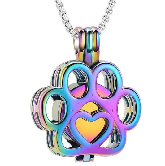 Front close-up view of the rainbow hollow paw print pet memorial keepsake pendant with fine filigree details.