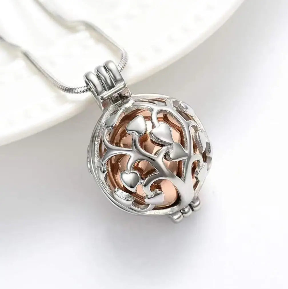 Tree of Life pet memorial urn necklace with a rose gold inner sphere.