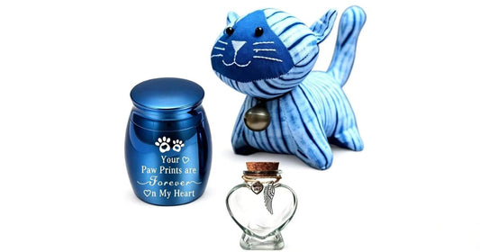 Handcrafted indigo shibori tie-dye plush cat with a mini blue pet cremation urn and a glass keepsake bottle, representing healing color psychology for pet loss.