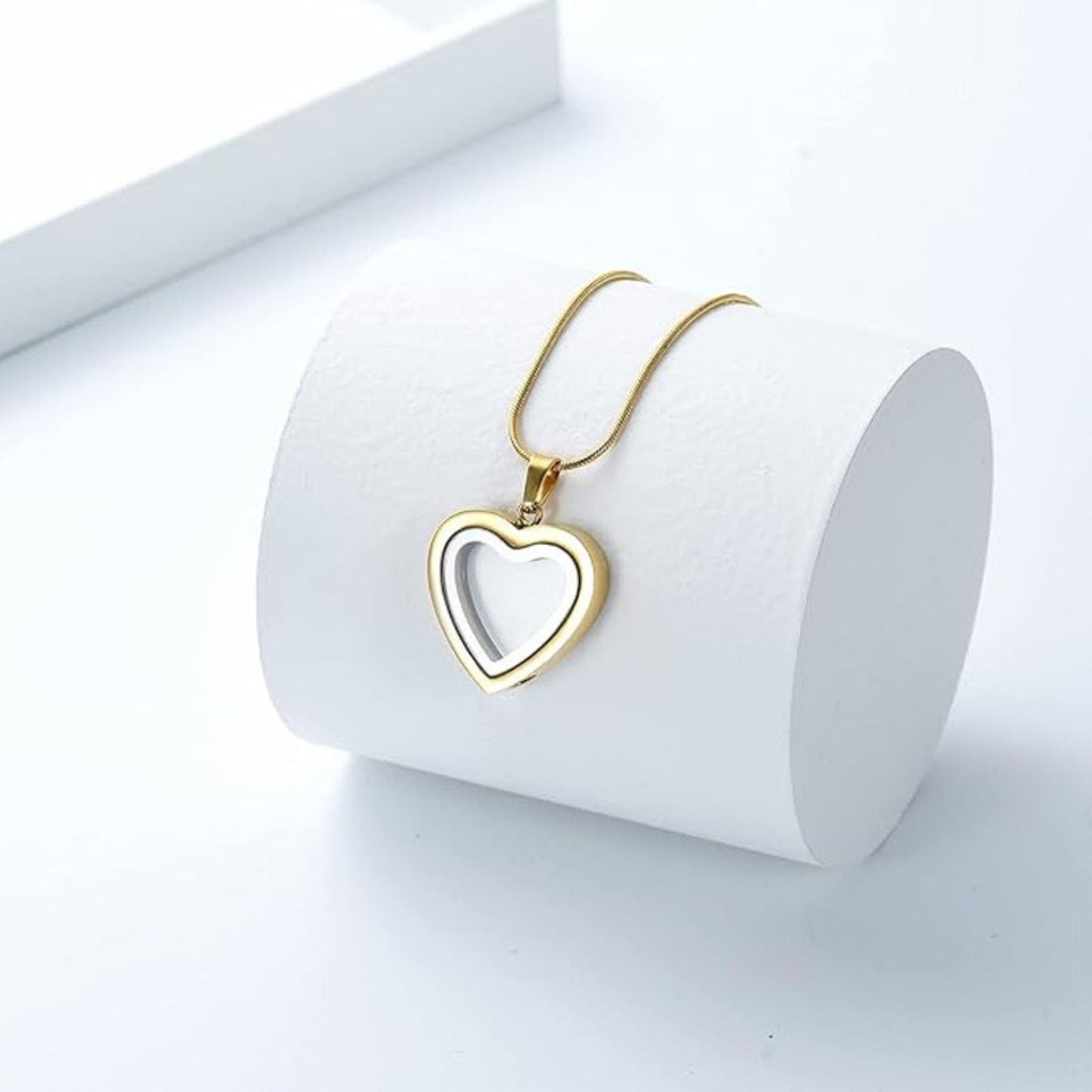 Close-up of heart urn necklace showing screw fill port and fillable chamber