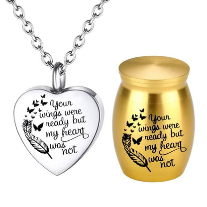 Gold mini pet keepsake urn with engraved feather and butterflies beside heart cremation necklace pendant