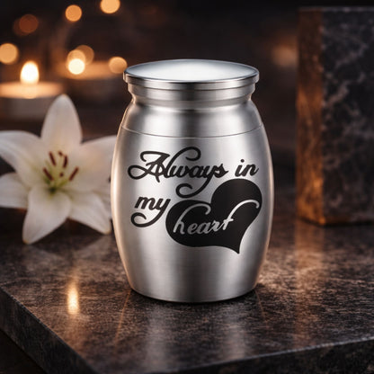 Silver  pet keepsake urn displayed on a table beside candles and follow