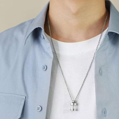 Model wearing clear glass urn necklace pendant on chain for scale