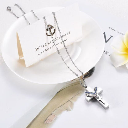 Close-up of stainless steel cross memorial pendant with blue birthstone crystals