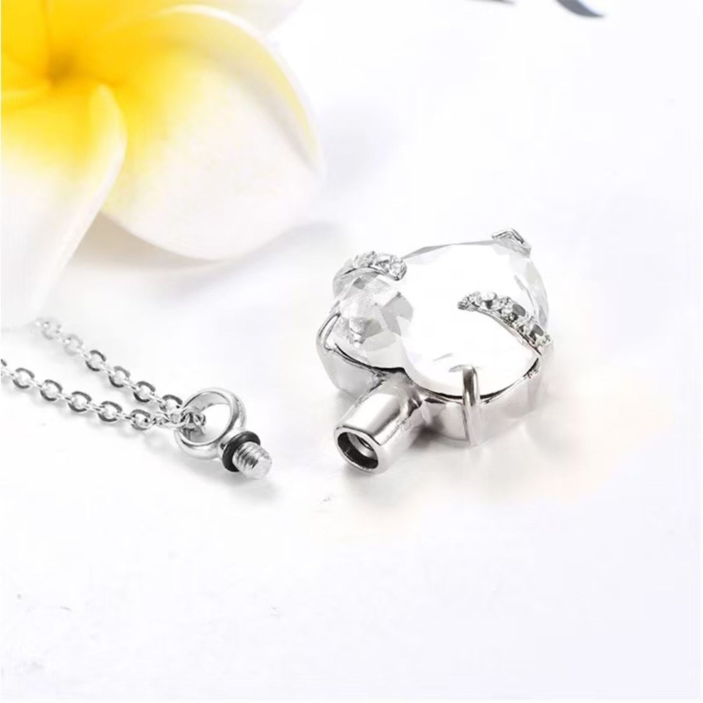 Close-up of heart urn necklace screw-top opening and stainless steel cap details