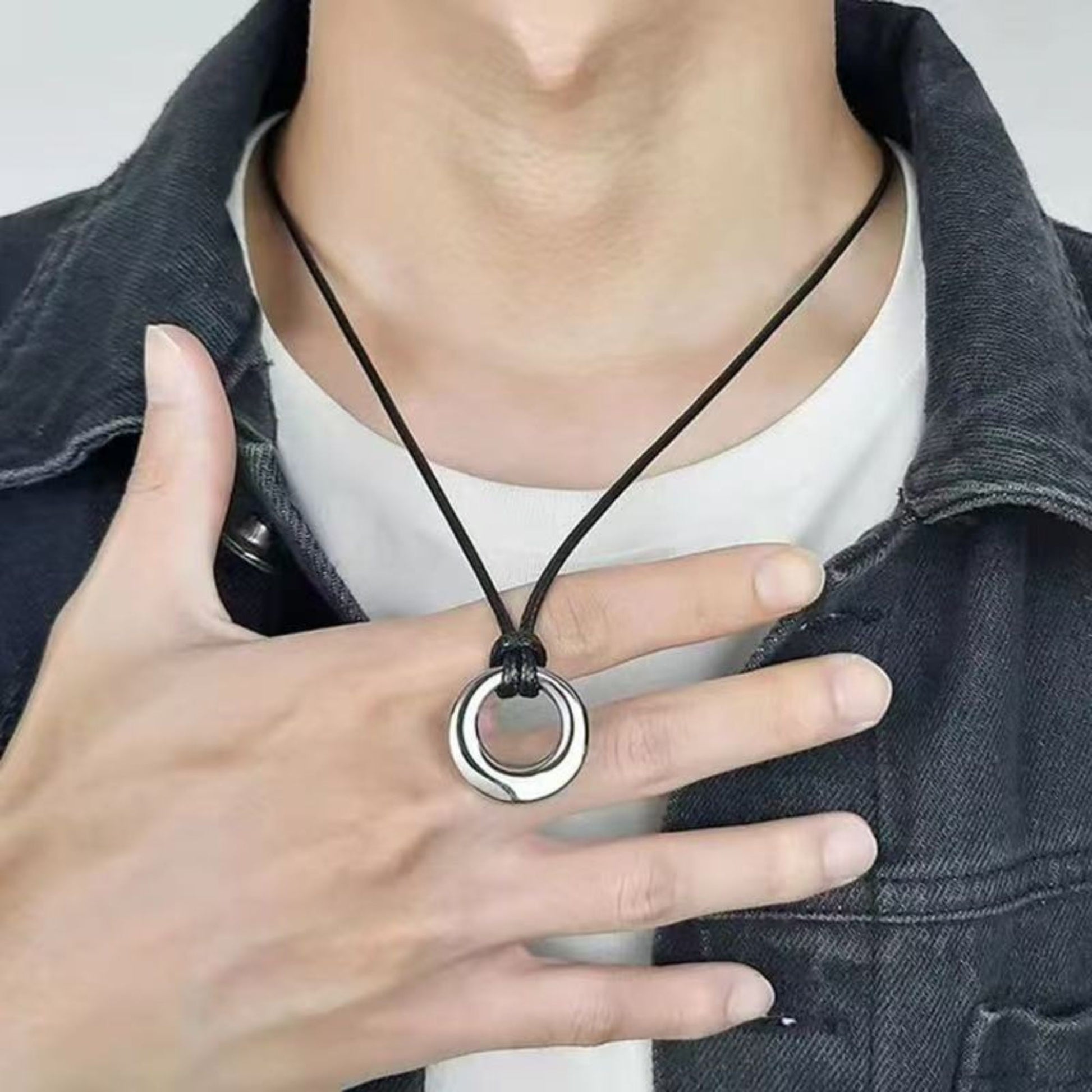 Person wearing hollow circle urn necklace with adjustable cord, minimalist memorial jewelry look