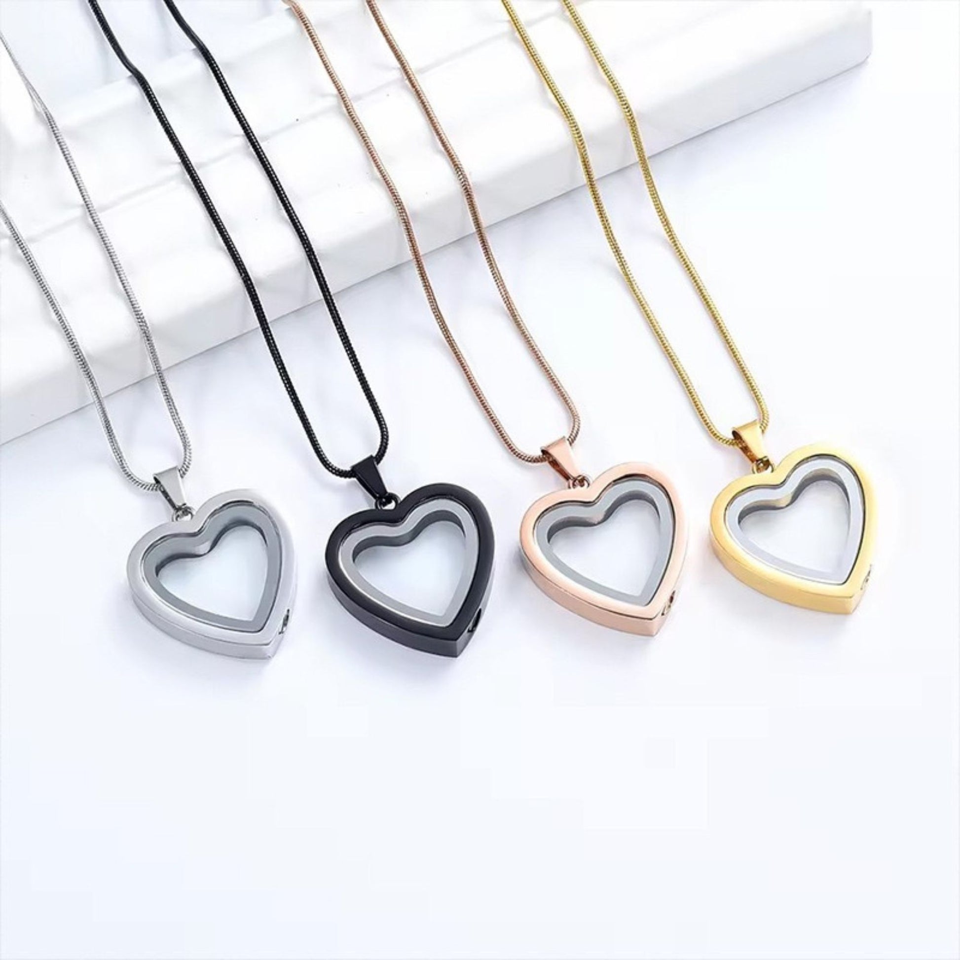 Heart-shaped fillable urn necklace set in silver, gold, rose gold, and black stainless steel