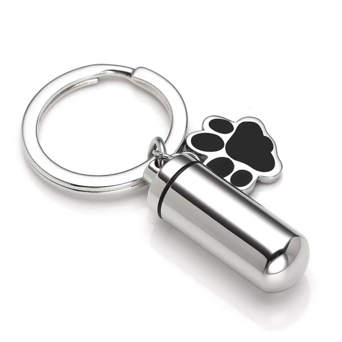 Silver stainless steel pet memorial ashes keychain urn with black paw charm and removable inner capsule on white background