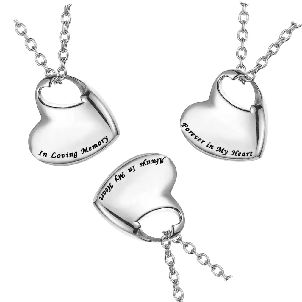 Highly polished heart-shaped cremation jewelry for pets ashes reflected on a mirror surface.