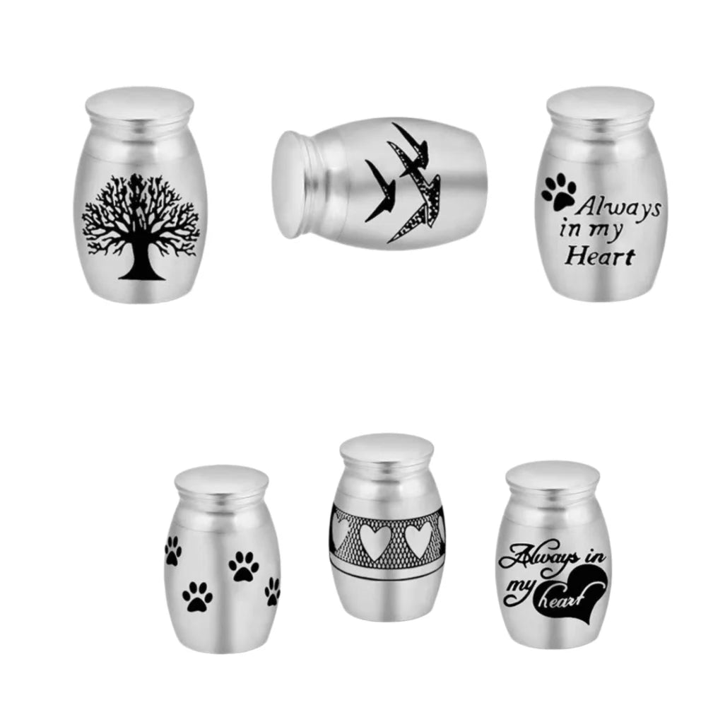 Six engraved variations of premium 316L stainless steel mini pet urns for cat and dog ashes.
