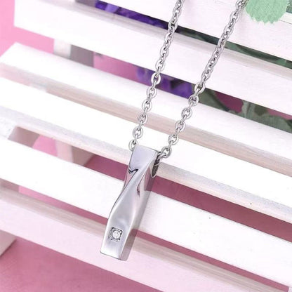 Lifestyle photo of minimalist bar cremation necklace worn on chain