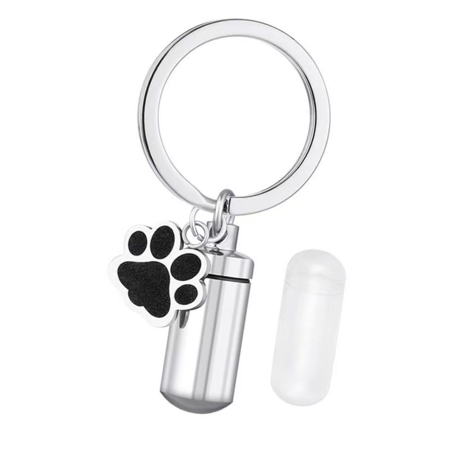 Disassembled stainless steel pet ashes keychain showing screw-top lid, inner capsule insert, and memorial urn body on dark background