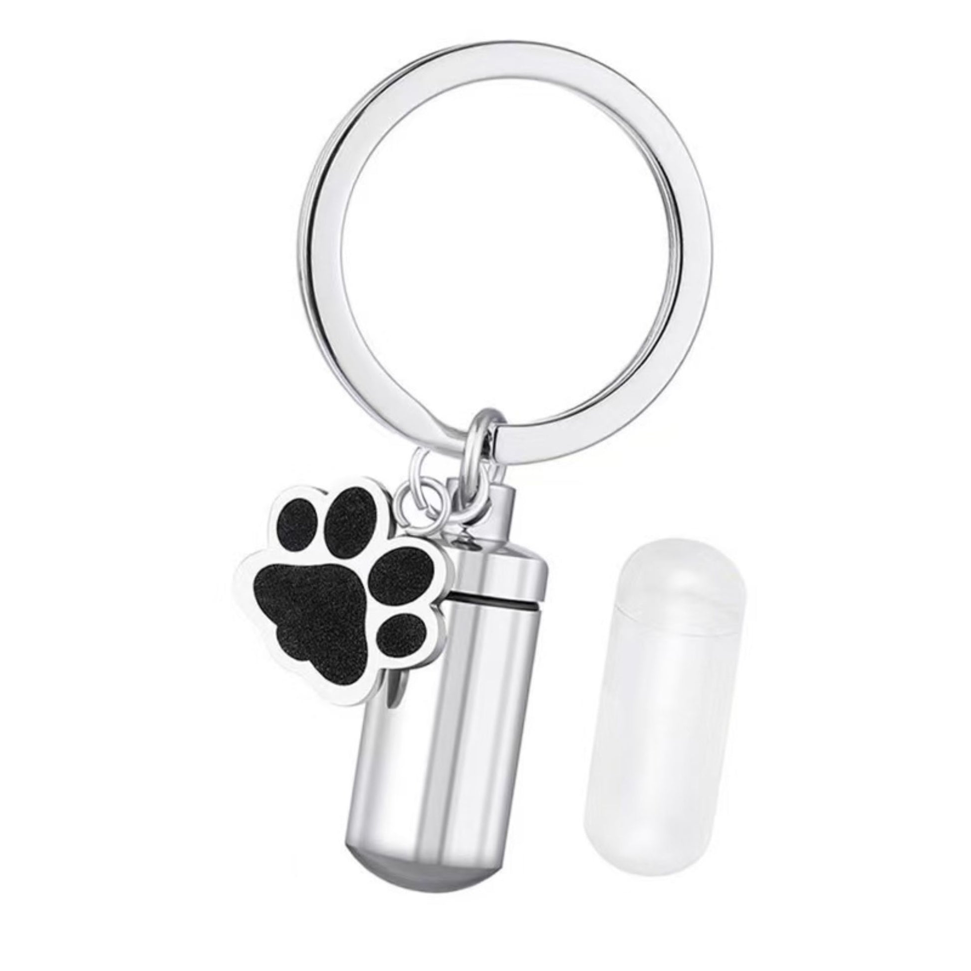 Disassembled stainless steel pet ashes keychain showing screw-top lid, inner capsule insert, and memorial urn body on dark background