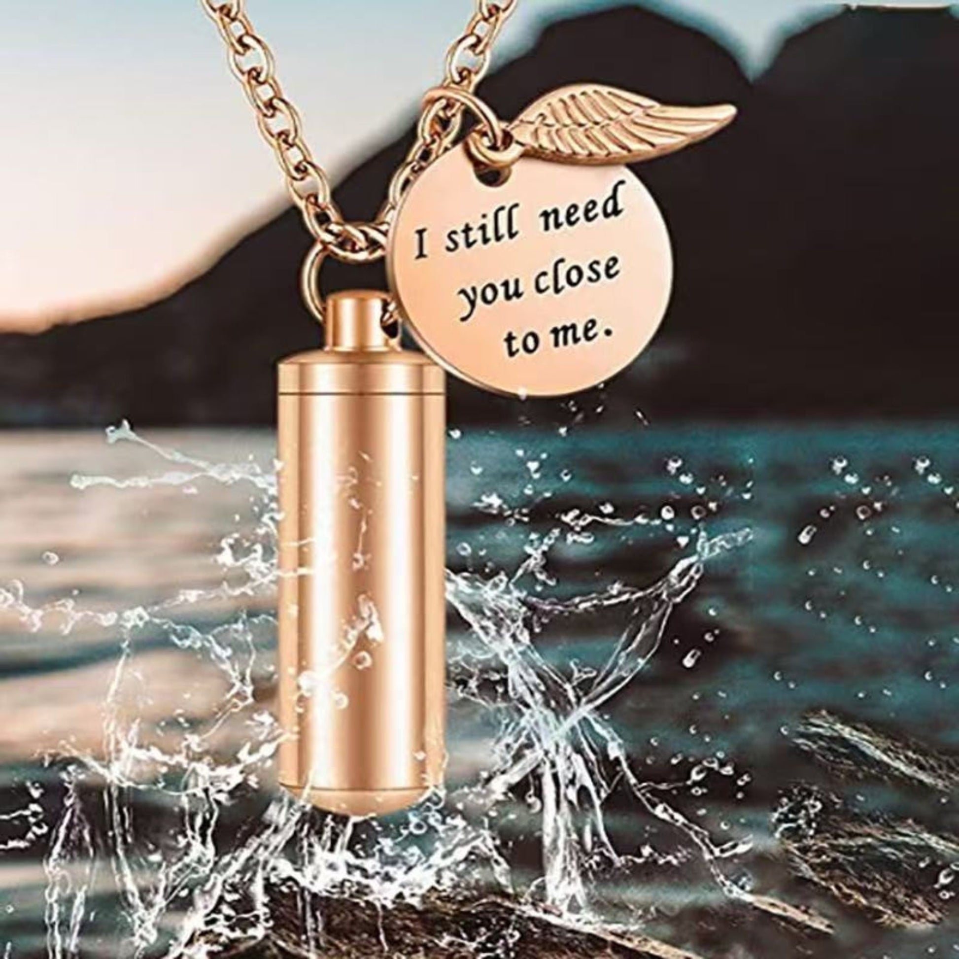 Rose gold stainless steel urn pendant necklace shown with water splash background