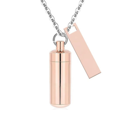 Gold Rose alloy capsule pet urn necklace with matching black tag on silver chain front view