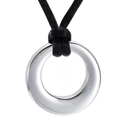 Close-up of silver hollow circle urn pendant on adjustable black cord necklace
