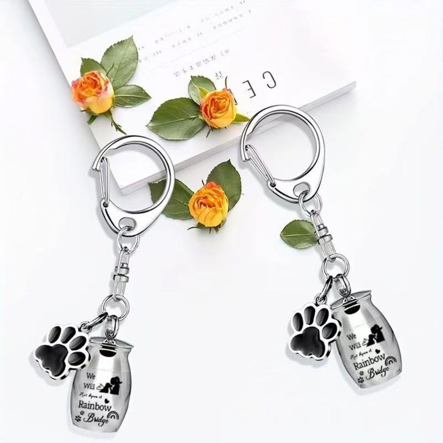 Stainless steel pet memorial urn keychain with paw charm in silver and black color options, Rainbow Bridge design, single-item variants
