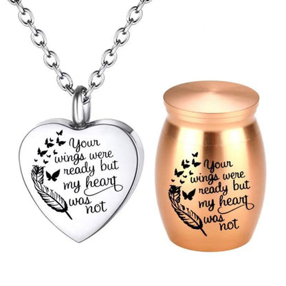 Rose Gold mini pet keepsake urn with engraved feather and butterflies beside heart cremation necklace pendant