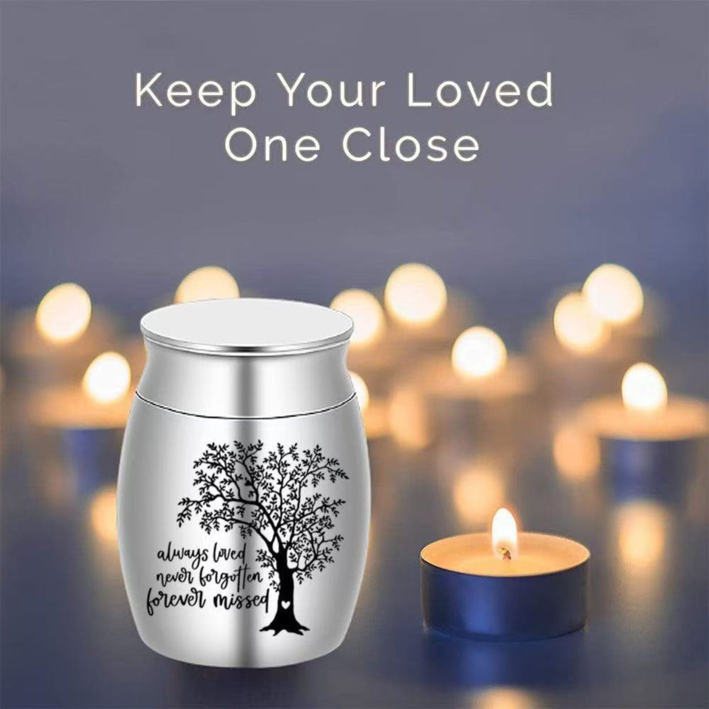 Silver Tree of Life pet keepsake urn displayed on a table beside candles and a pet photo frame
