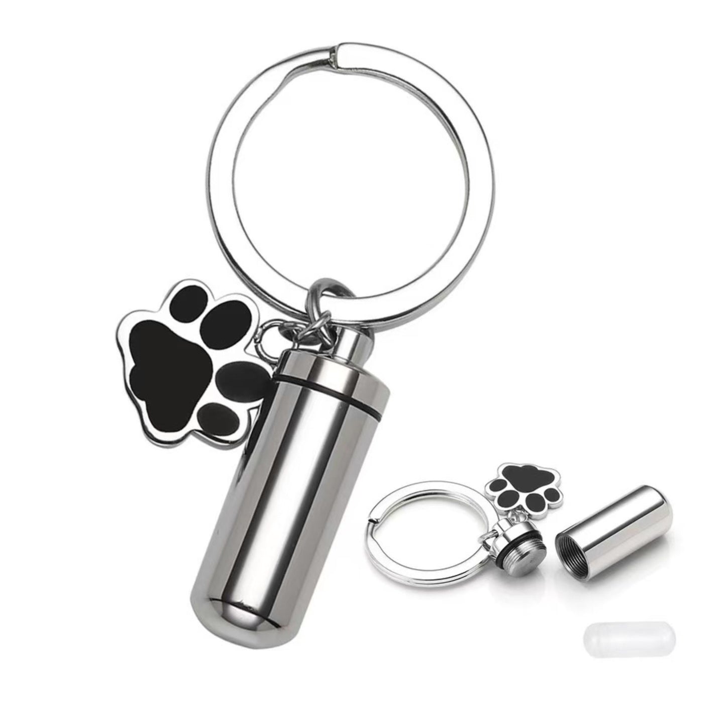 Close-up of silver pet memorial keepsake urn keychain with paw charm, opened screw-top design, and inner capsule insert
