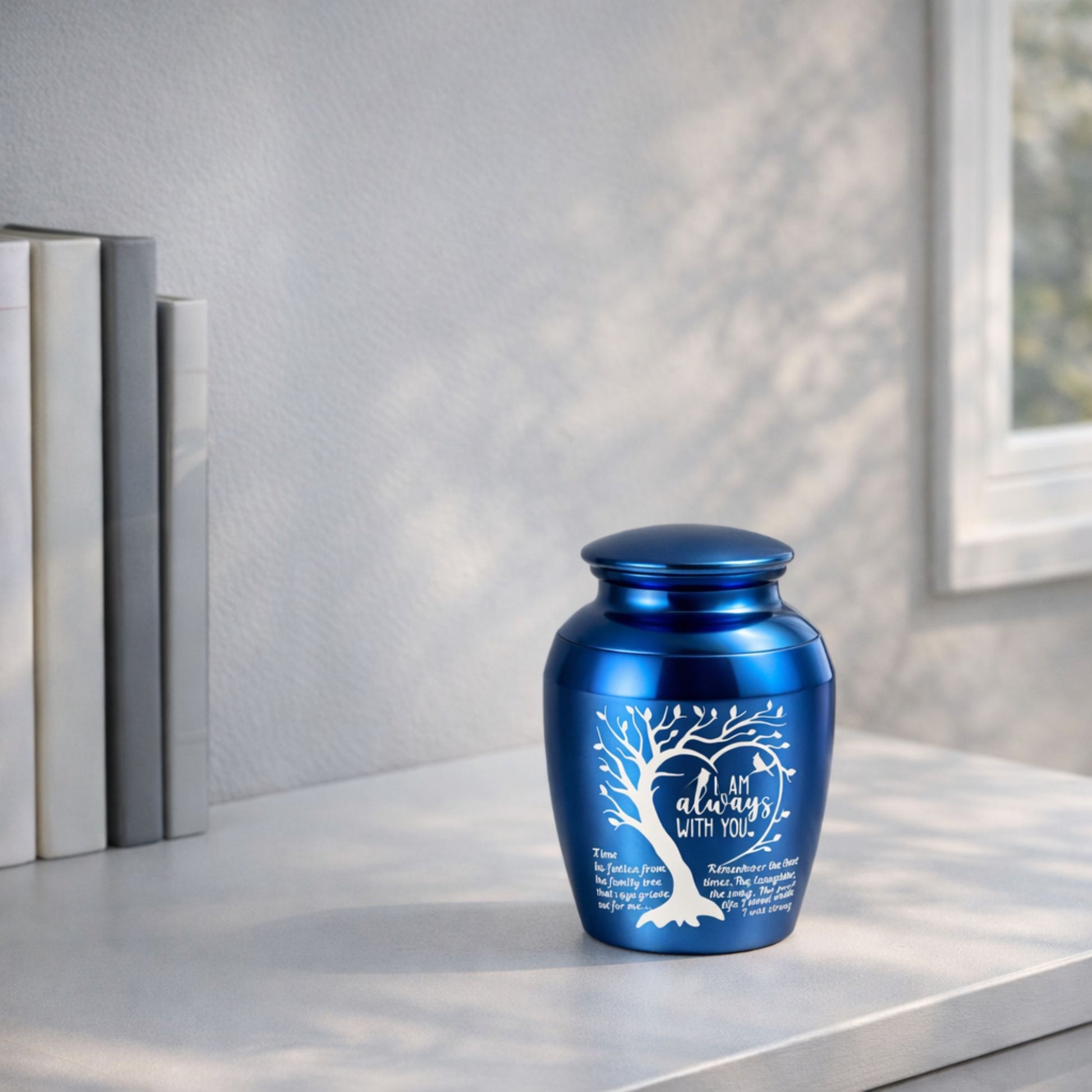  Blue “I Am Always With You” memorial urn displayed on a tabletop near books and a window