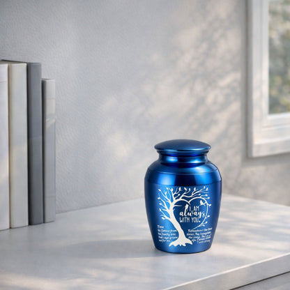  Blue “I Am Always With You” memorial urn displayed on a tabletop near books and a window