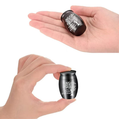  Mini black Tree of Life pet keepsake urn shown in hand for scale (small, discreet keepsake size)