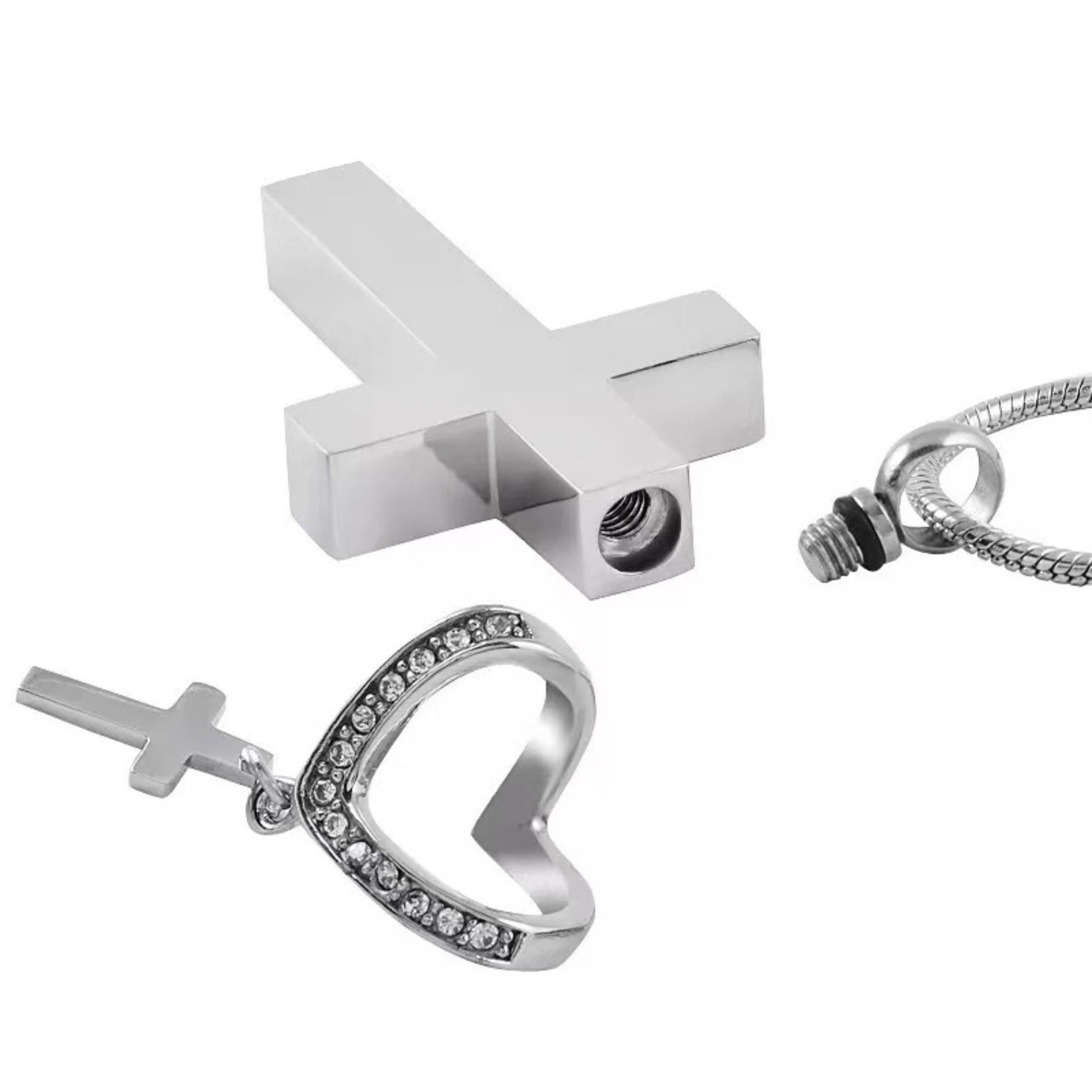 Close-up of cross urn pendant parts showing screw closure and heart accent with mini cross charm