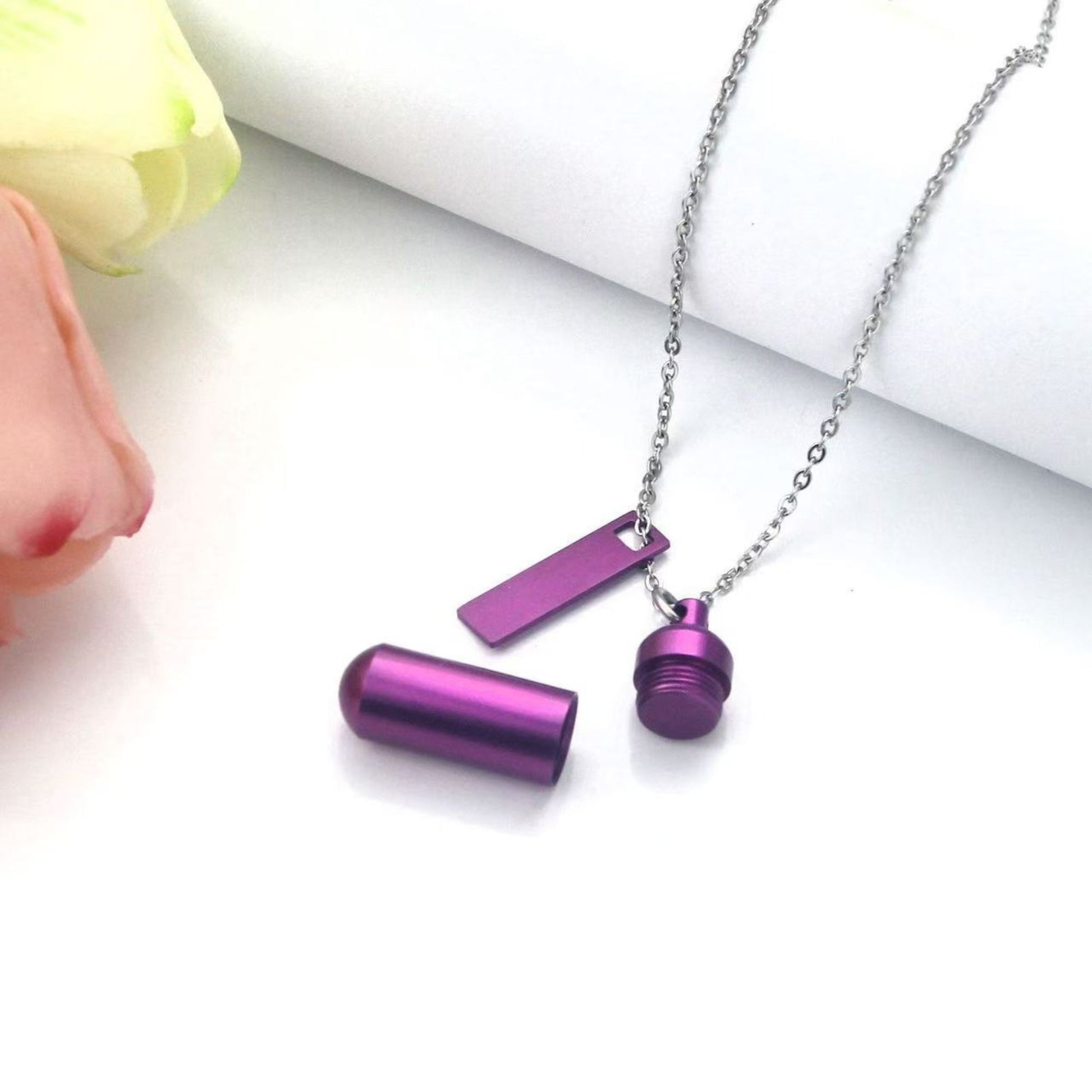 Open capsule pendant showing screw-top design with purple memorial keepsake necklace