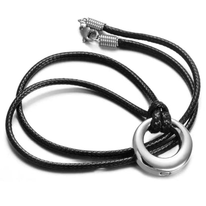 Silver hollow circle memorial pendant necklace lifestyle photo on display surface
