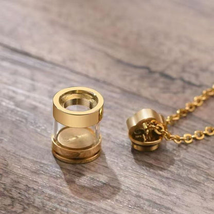 Gold clear glass urn necklace pendant with screw-top closure shown open