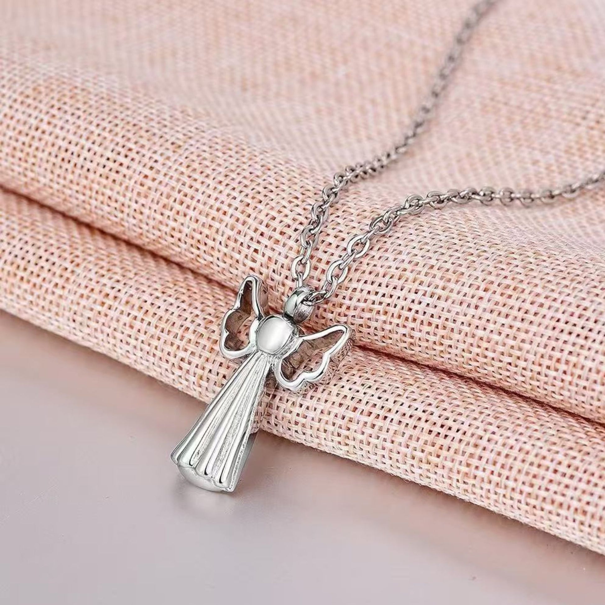 Lifestyle image: Angel wings pet memorial necklace worn on chain as a discreet keepsake remembrance jewelry