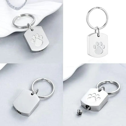 "Pet memorial keychain with paw print and heart-shaped charm, a touching keepsake for pet lovers."