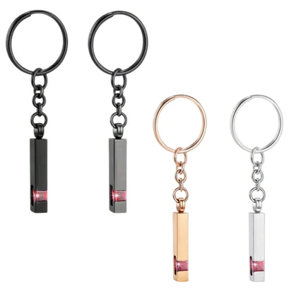 Pet memorial Urn keychain featuring a paw print design, available in black, silver, and rose gold colors. Comes with small tools (funnel, needle) for easy use, ideal for holding small keepsakes like pet fur or ashes.