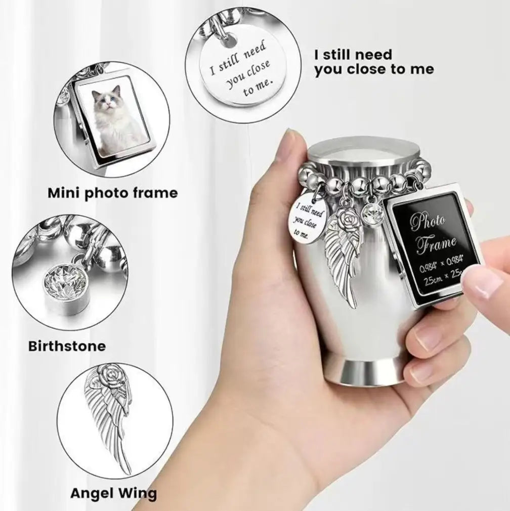Close up details of the dog memorial picture frame locket charm alongside birthstone crystal and detailed silver angel wing.