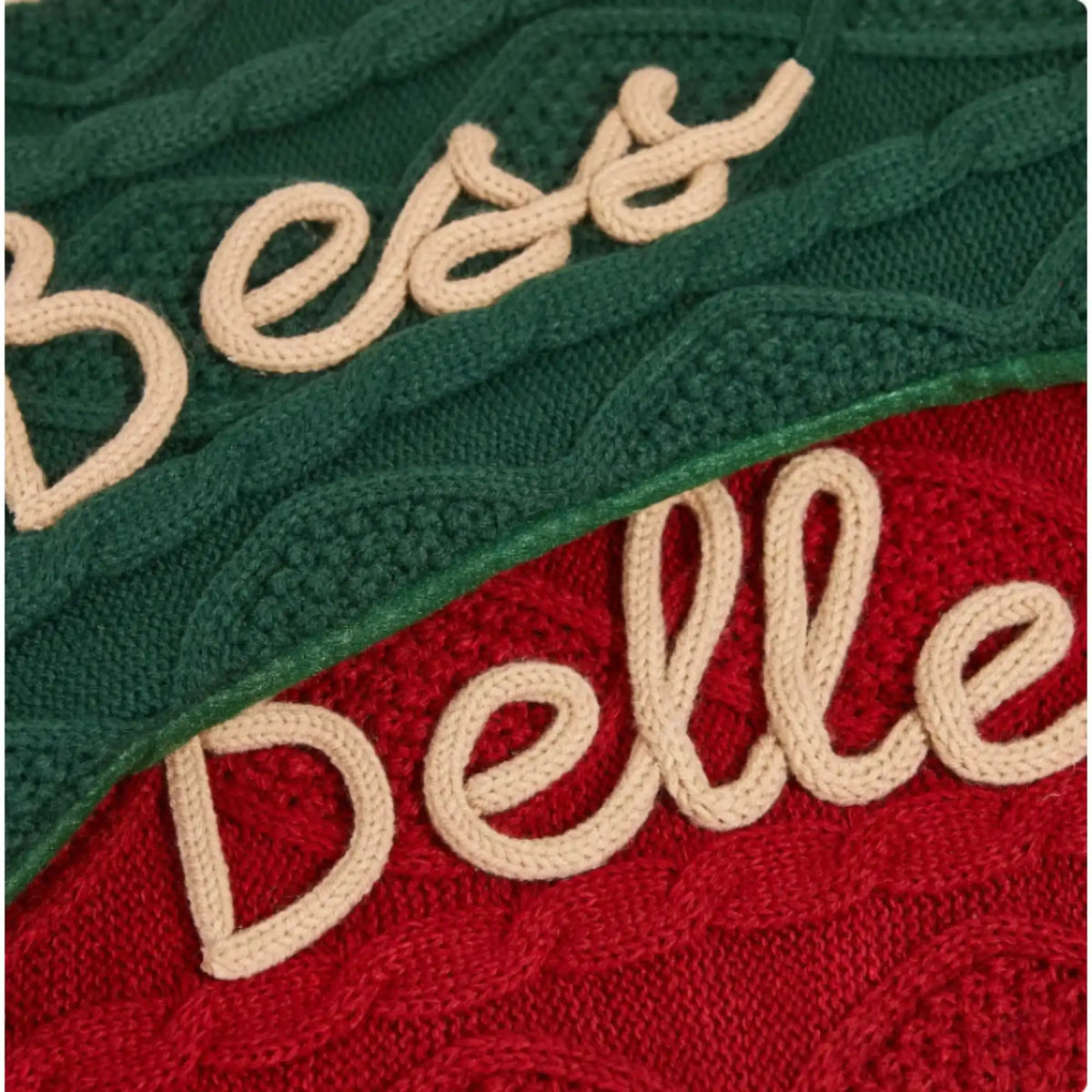 Close-up of personalized embroidered dog name on a knitted Christmas stocking