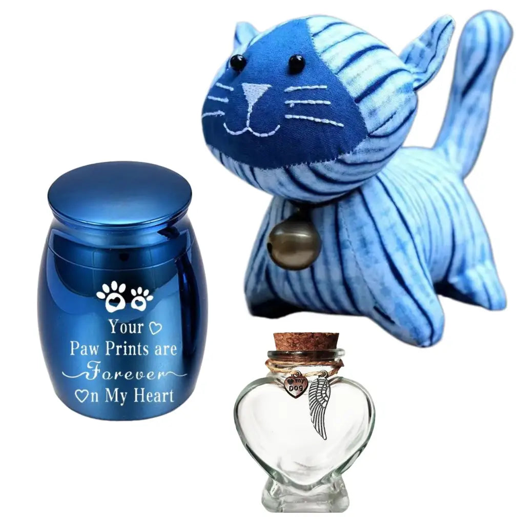Complete handmade cat memorial gifts set including a blue tie-dye fabric plush cat, a metallic blue mini pet urn for ashes, and a heart glass hair vial.