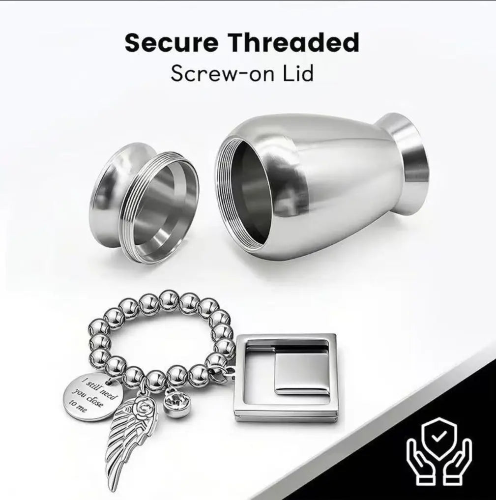 Threaded lid opening of pet urns for cremation displaying a detachable beaded charm loop with a custom photo locket.
