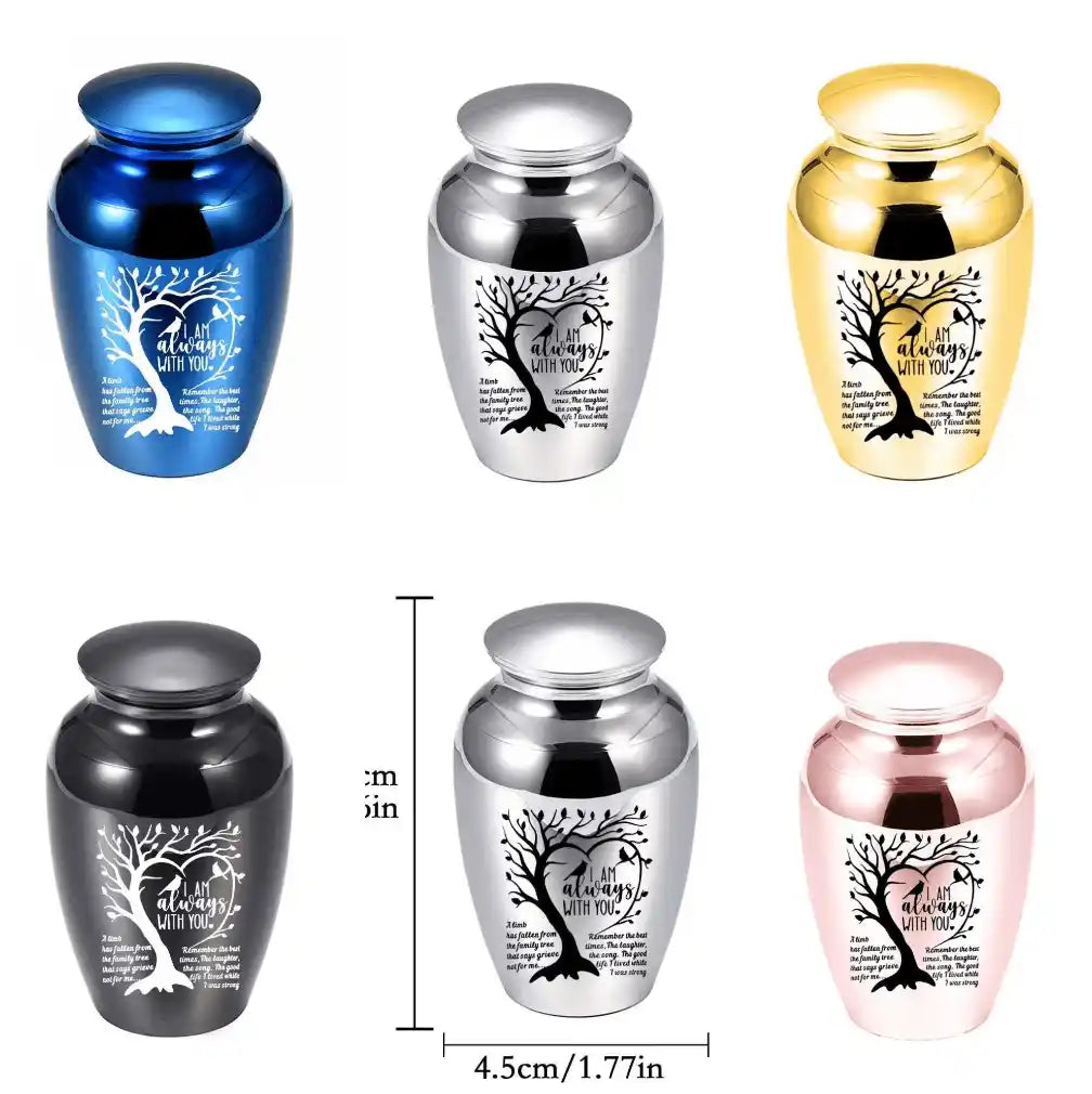 Small pet memorial urns in blue, silver, gold, black, and pink, featuring engraved tree artwork and remembrance quote for dog or cat ashes.
