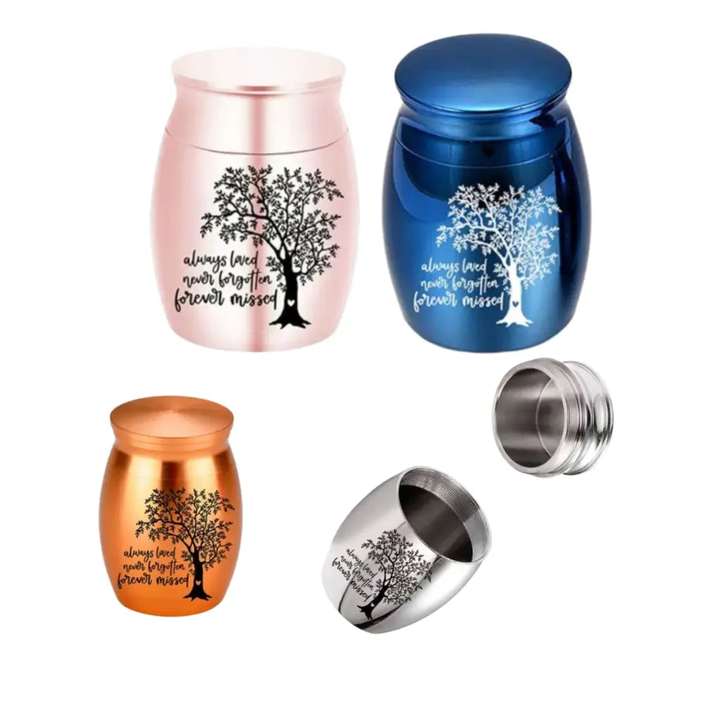 Four color variations including pink gold, deep blue, amber bronze, and midnight silver of the perfect memorials pet urns featuring the tree of life.
