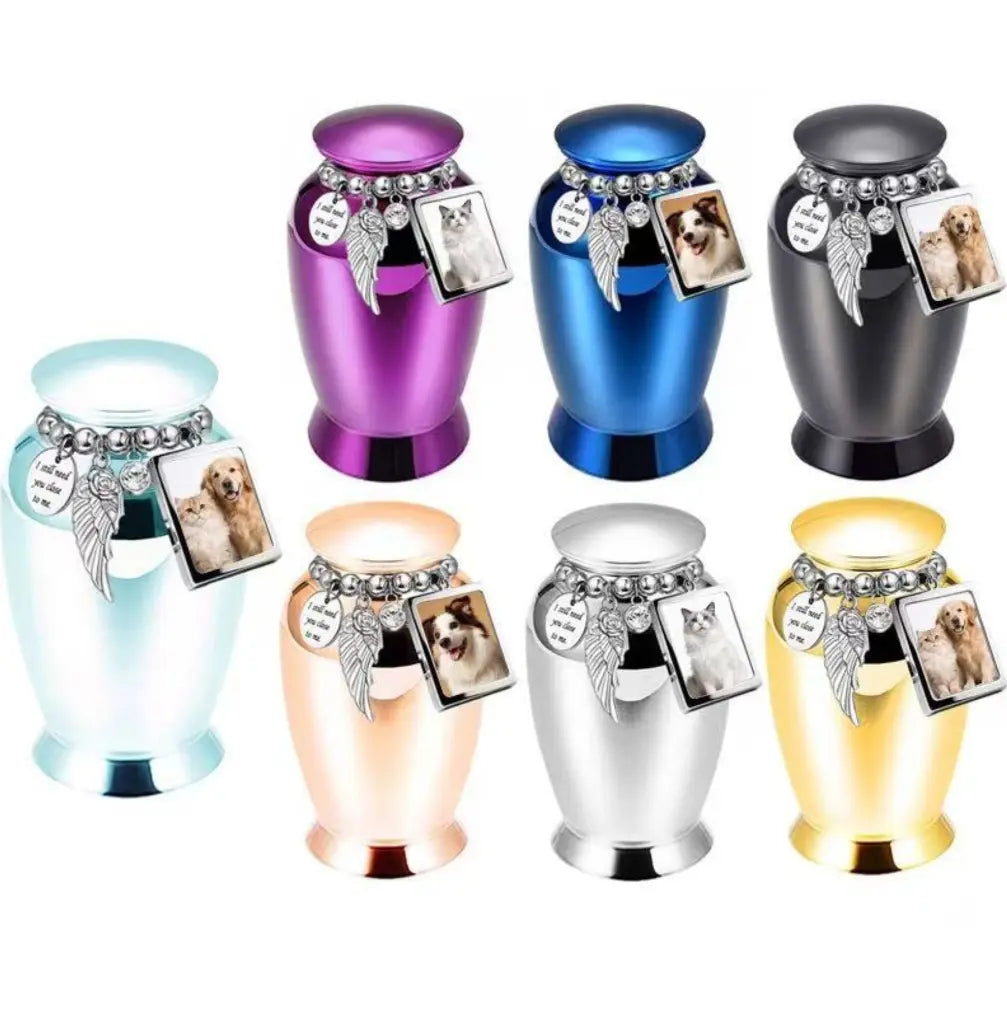 Seven beautiful metallic colors of the perfect memorials pet urns featuring a beaded charm loop and a mini photo frame.