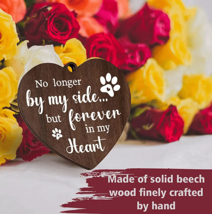 Close-up of the heart-shaped wooden charm engraved with a touching pet tribute poem and paw print.