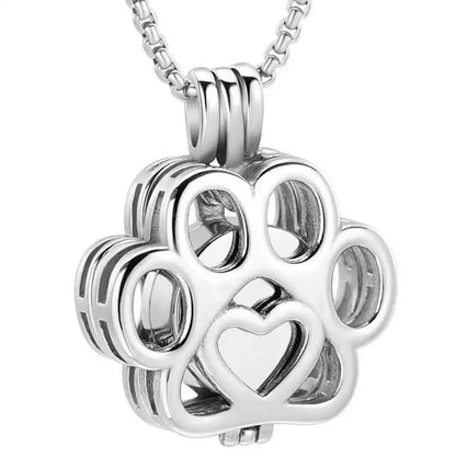 Front close-up view of the silver hollow paw print pet memorial keepsake pendant with fine filigree details.
