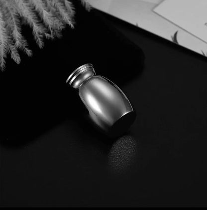 Mini black  pet keepsake urn shown  (small, discreet keepsake size)