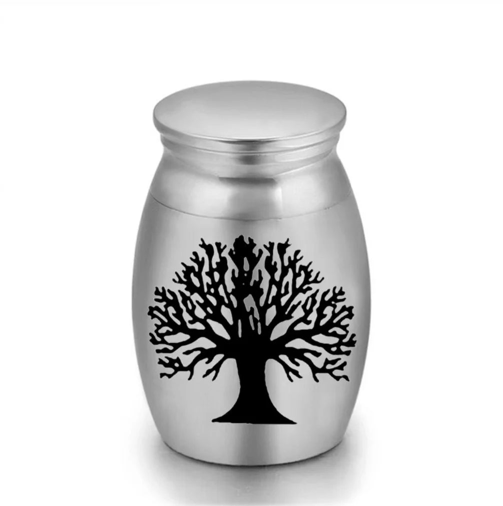 Isolated front view of the ultra-miniature 316L stainless steel pet keepsake urn featuring black laser-etched paw prints.